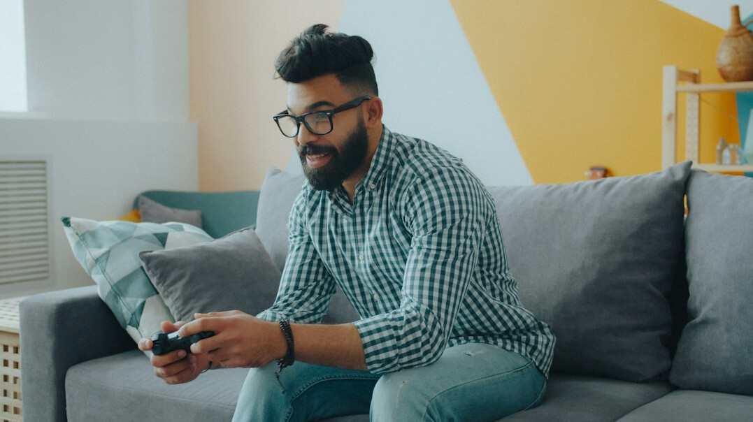 Software developer working on insurance platform code on a laptop in a bright office