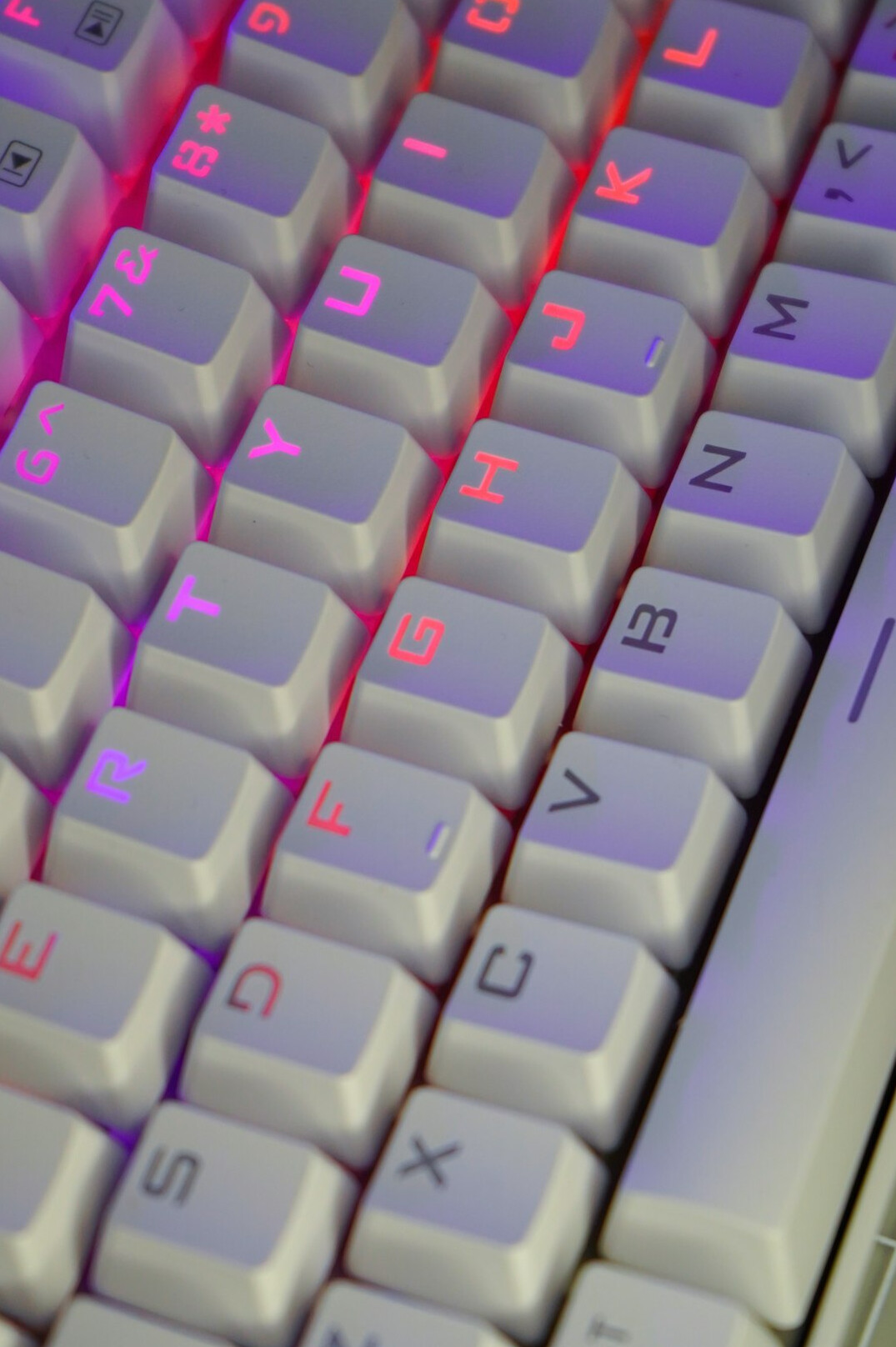 Close-up of hands typing on a laptop keyboard with code editor open